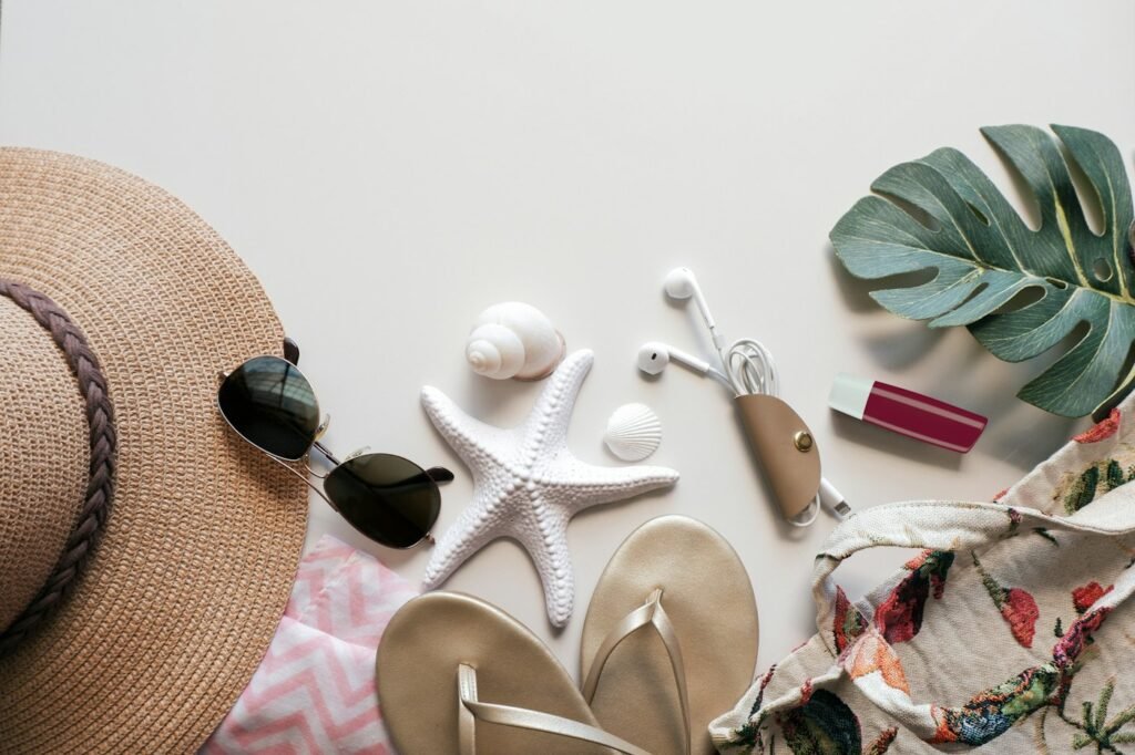 Beach flat lay with sandals, shells and a cover-up