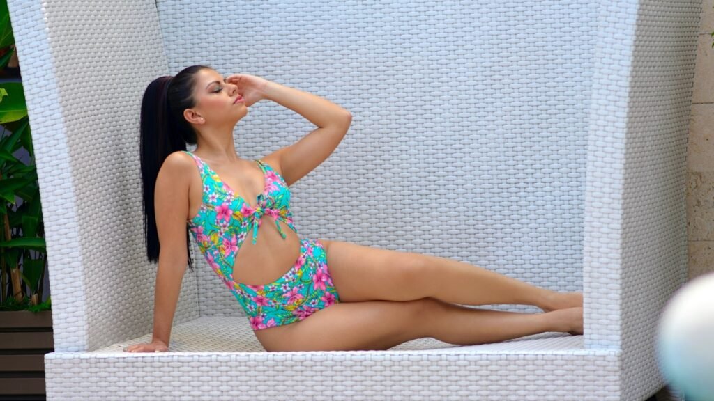 Woman in bright floral cut-out one-piece