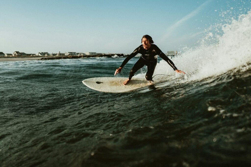 Surfer in a full wetsuit catching a wave