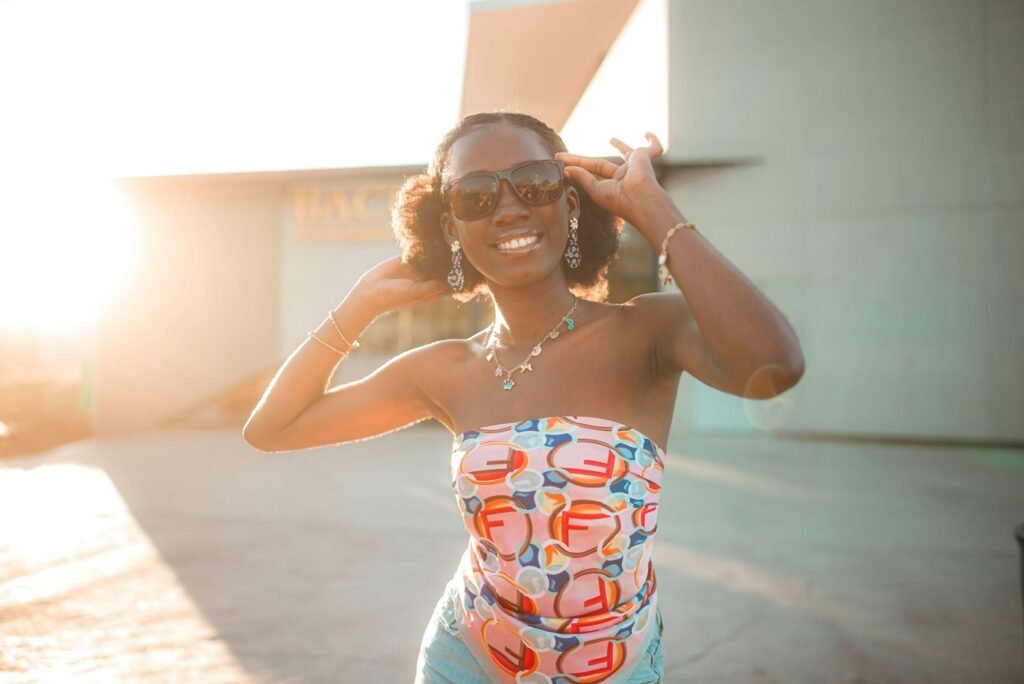 Smiling woman in patterned strapless swimsuit and sunglasses