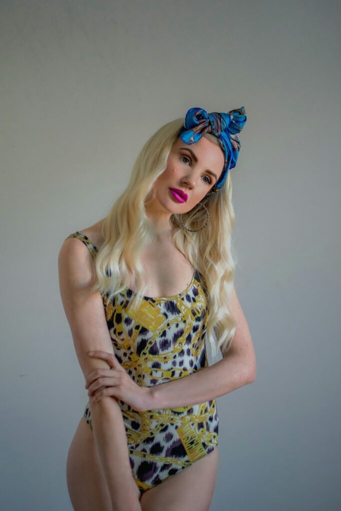 Woman in leopard print one-piece and head scarf