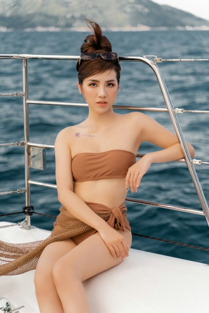 Woman in brown bandeau bikini with sarong on a boat