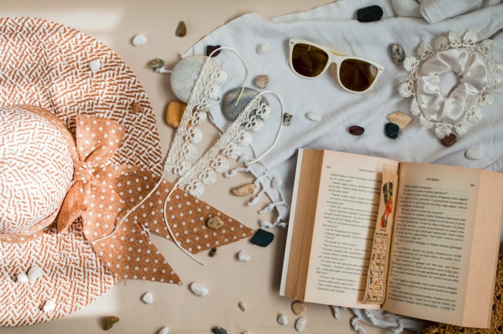 Beach flat lay with straw hat, shells and sunglasses