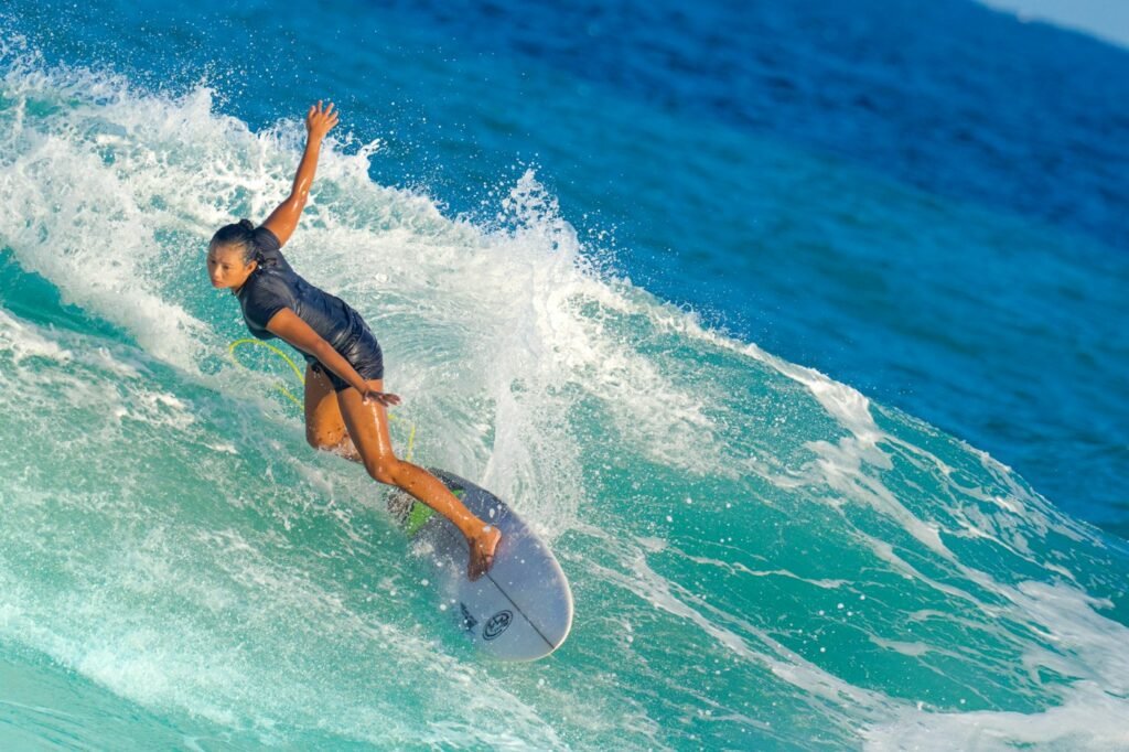 Surfer carving a wave in a short-sleeve surf suit