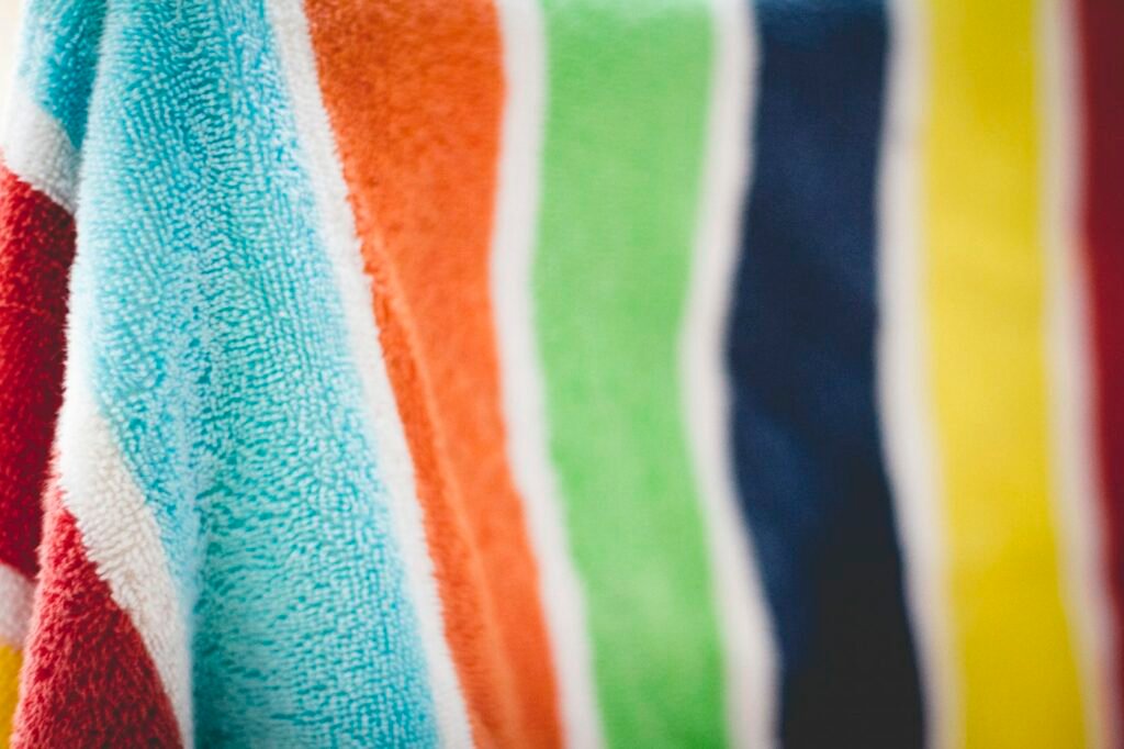 Stack of bright striped beach towels