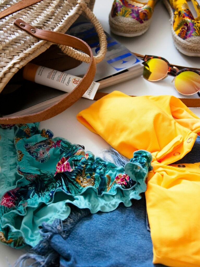 Yellow and floral bikini with straw bag and sunglasses
