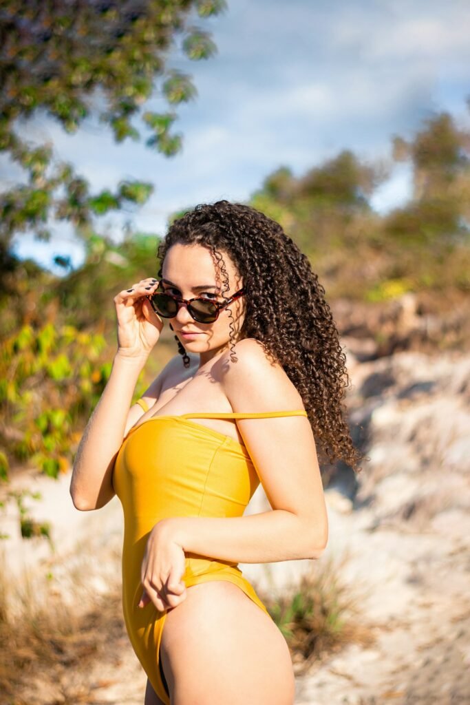 Woman in yellow scoop one-piece with sunglasses