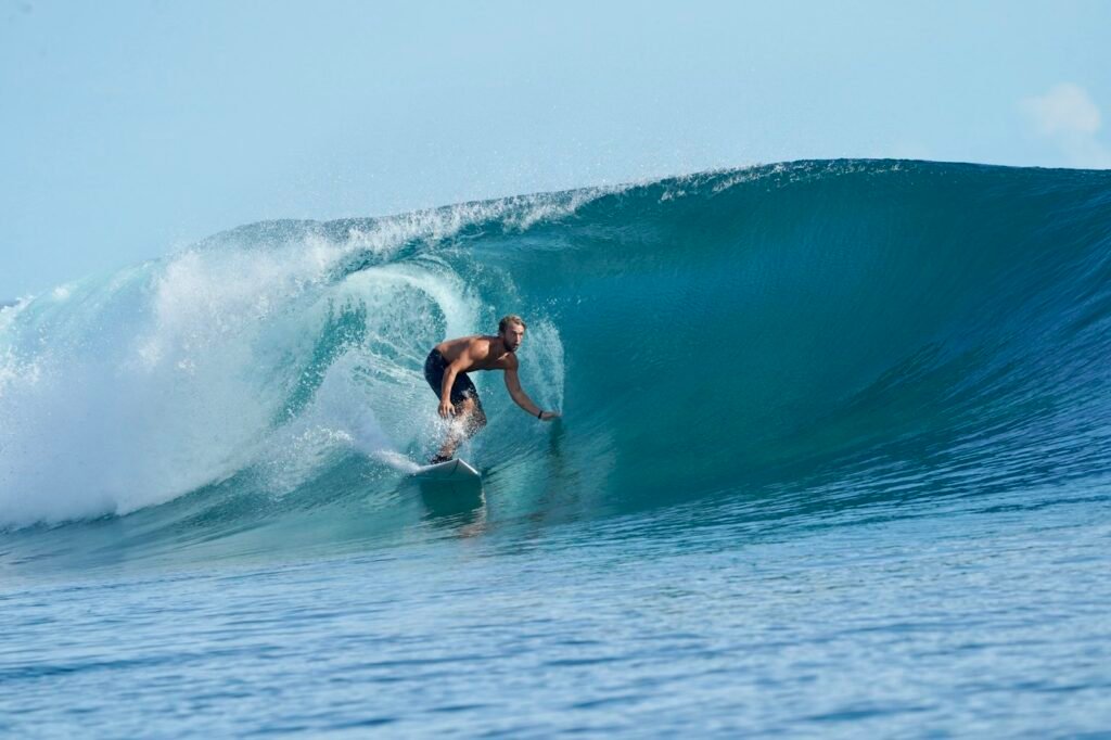 Surfer riding inside a turquoise wave