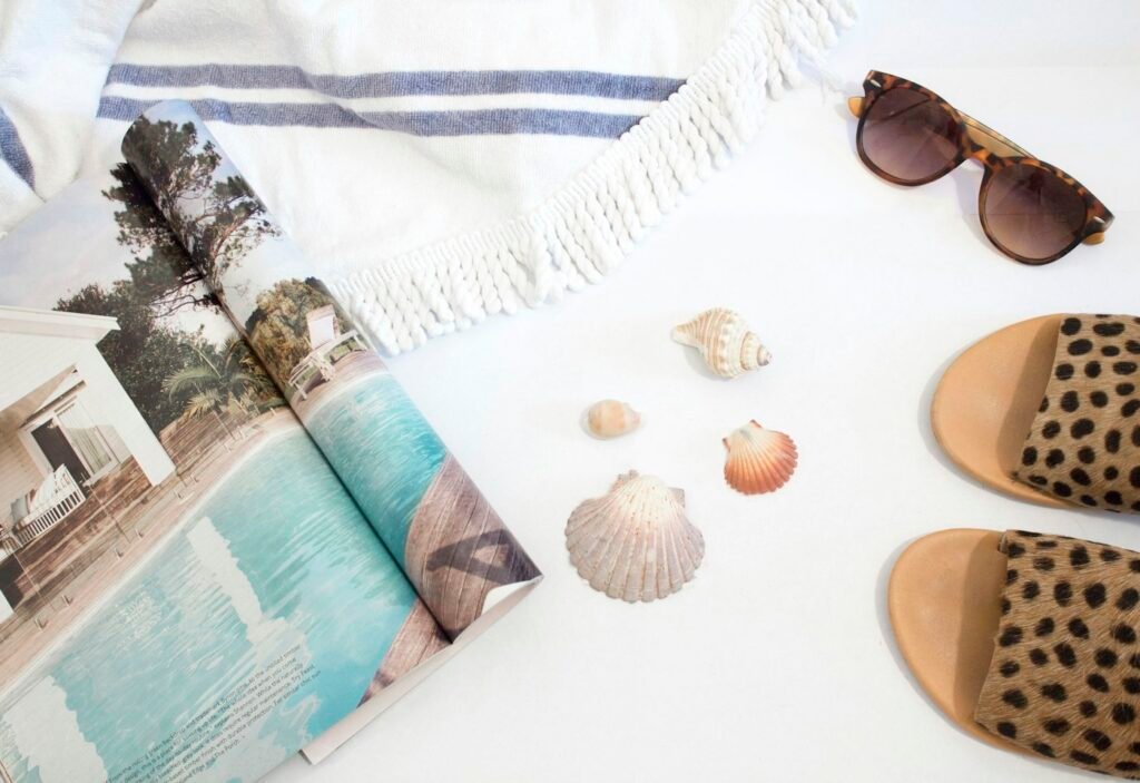 Striped Turkish towel and magazine with shells