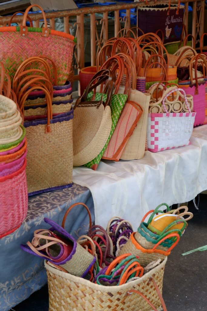 Colorful woven straw beach bags at a market stall