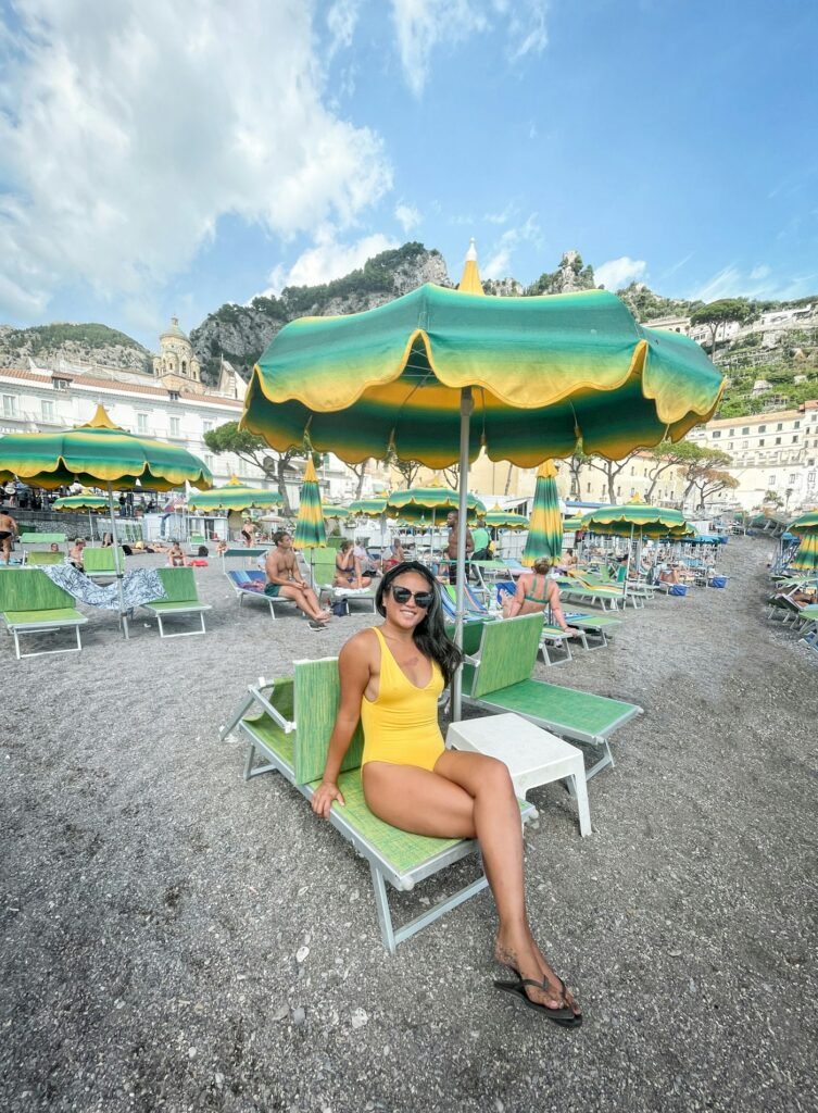 Woman in yellow one-piece on a beach lounger